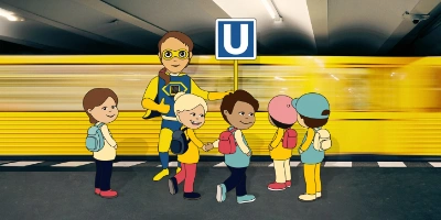 Im Vordergrund ist Bahnuel und eine Gruppe von Kindern. Im Hintergrund ist eine U-Bahn.